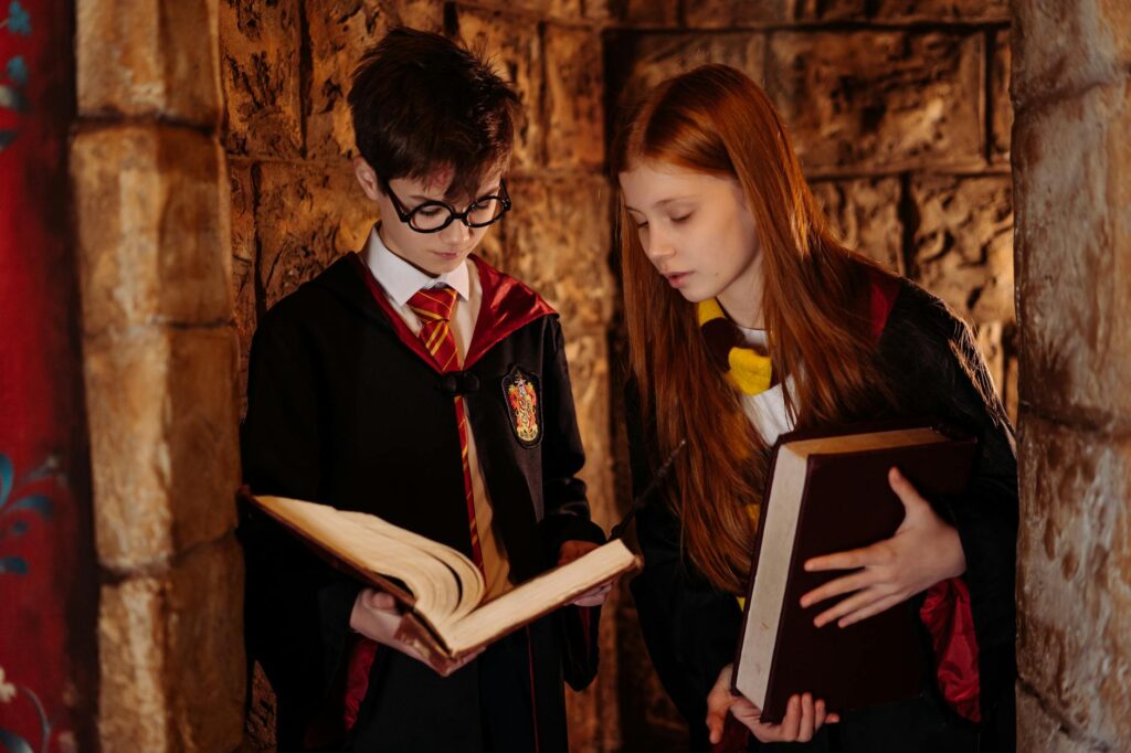 a boy and a girl wearing harry potter costumes