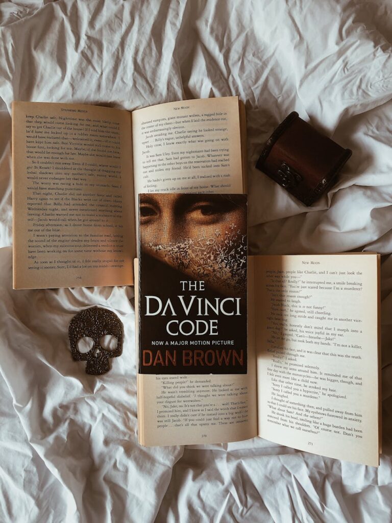 opened books on white bedding